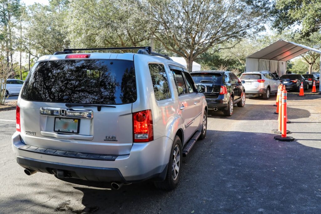 Vehicles queued at an outdoor car wash bay